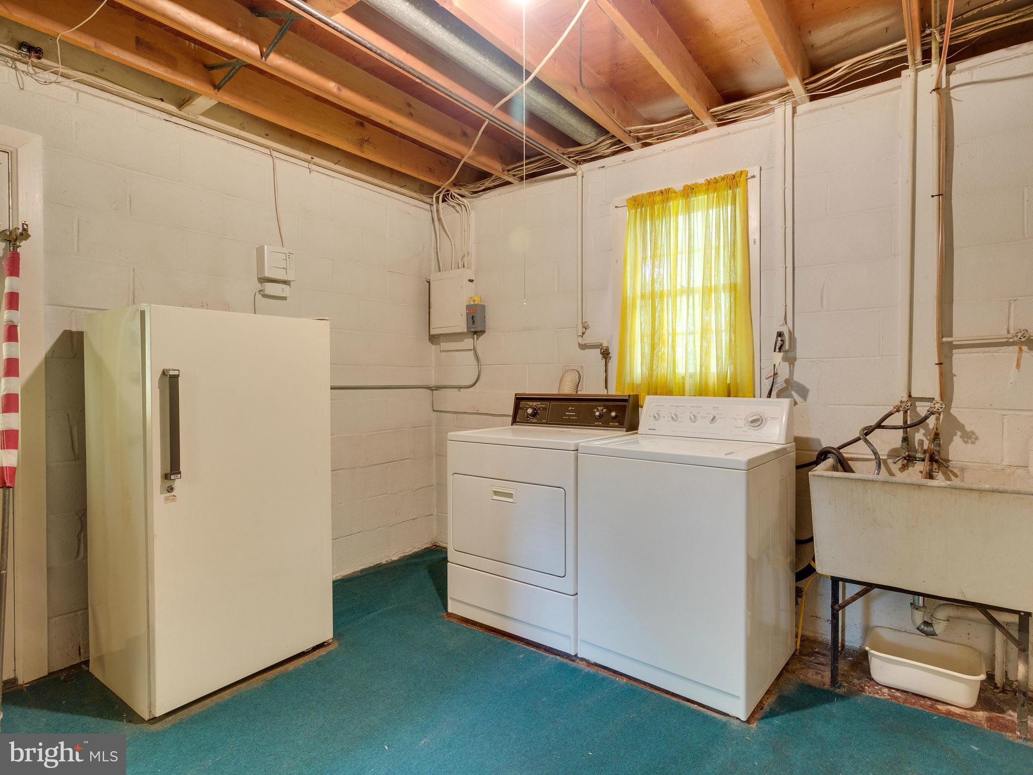 8207 Old Oaks Drive Springfield, VA 22152 - Photo 23 of 30 a utility room with cabinets washer and dryer