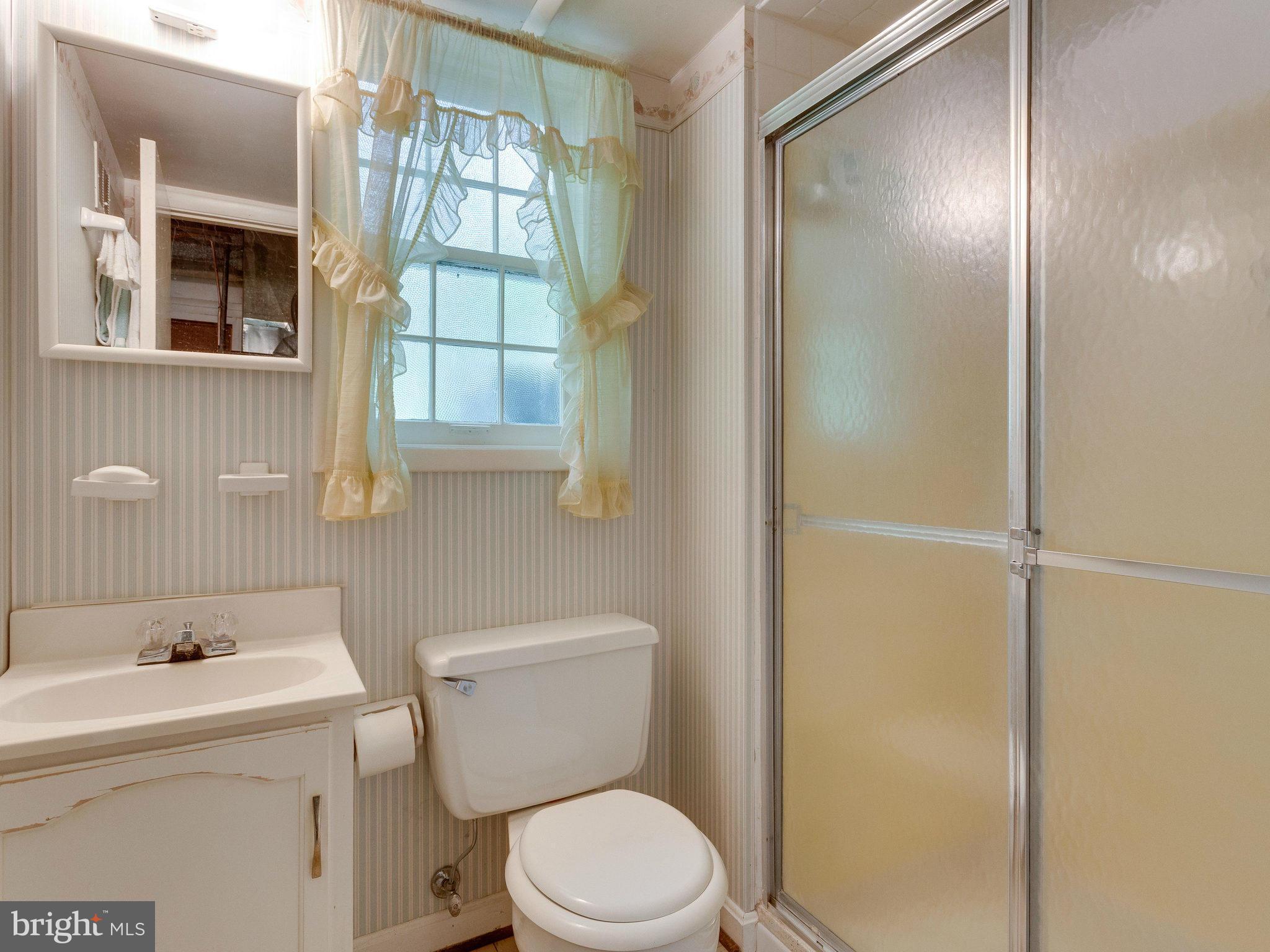 8207 Old Oaks Drive Springfield, VA 22152 - Photo 24 of 30 a white toilet sitting next to a bathroom sink