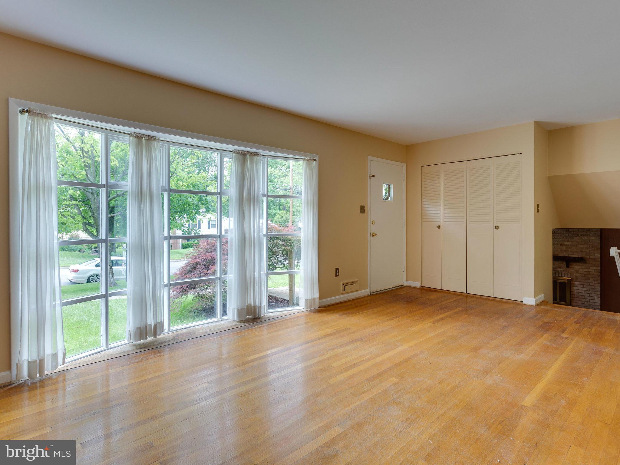 8207 Old Oaks Drive Springfield, VA 22152 - Photo 5 of 30 a view of an empty room with wooden floor and a window
