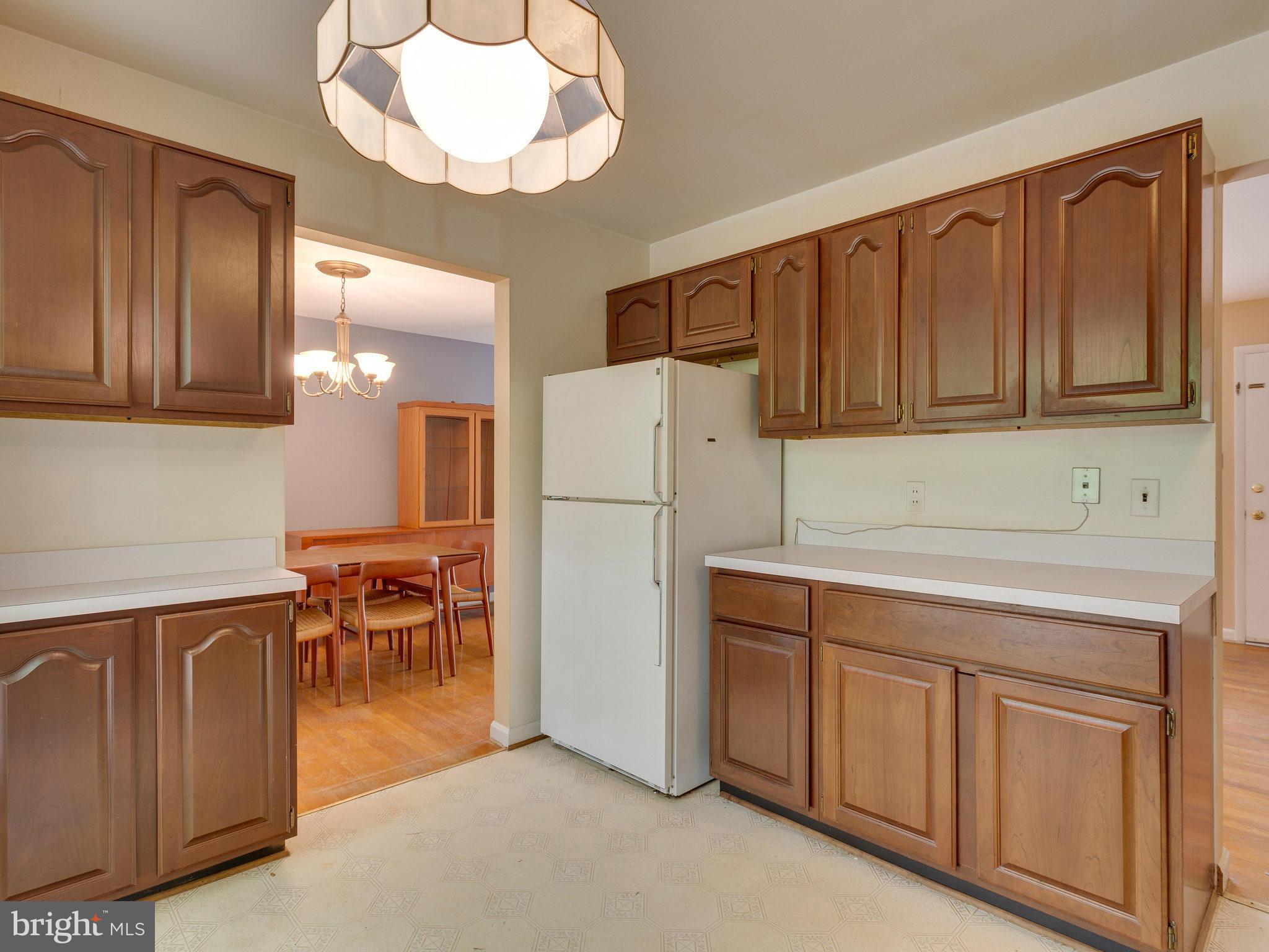 8207 Old Oaks Drive Springfield, VA 22152 - Photo 9 of 30 a kitchen with cabinets and stainless steel appliances