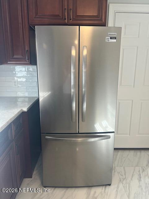 312 East Market Road Starke, FL 32091 - Photo 25 of 46 a view of a refrigerator in kitchen and stainless steel appliances wooden cabinet