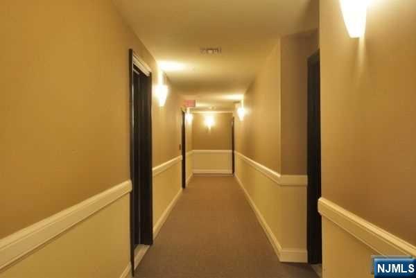 29 1st Street, Unit 401 Hackensack, NJ 07601 - Photo 24 of 26 a view of a hallway with wooden floor