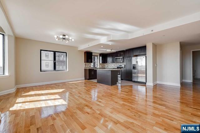29 1st Street, Unit 401 Hackensack, NJ 07601 - Photo 3 of 26 a view of kitchen with stainless steel appliances granite countertop cabinets and wooden floor