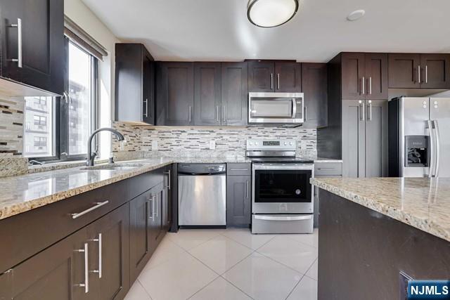 29 1st Street, Unit 401 Hackensack, NJ 07601 - Photo 5 of 26 a kitchen with granite countertop stainless steel appliances and cabinets