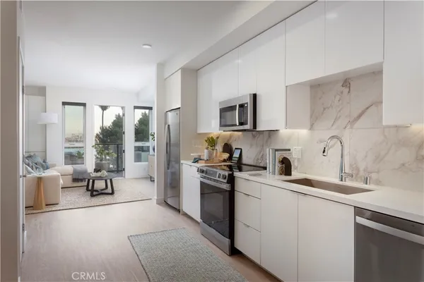 a kitchen with a sink appliances and cabinets
