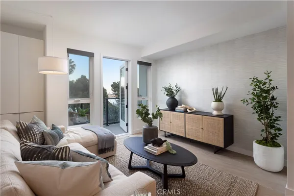a living room with furniture potted plant and a window