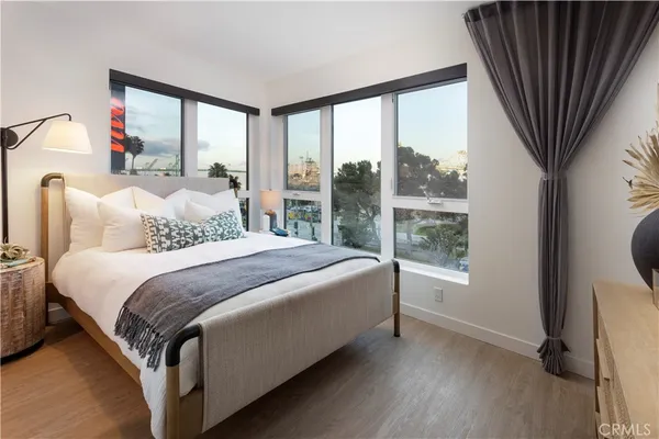 a bedroom with a bed and a large window