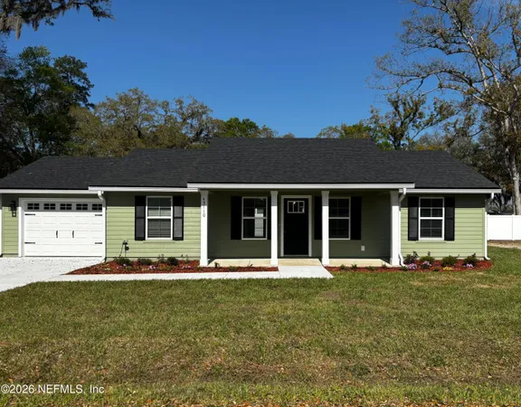 a kitchen with stainless steel appliances granite countertop a stove top oven a refrigerator a sink and dishwasher with wooden floor