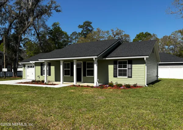 a kitchen with stainless steel appliances granite countertop a stove a sink dishwasher and a refrigerator with wooden floor