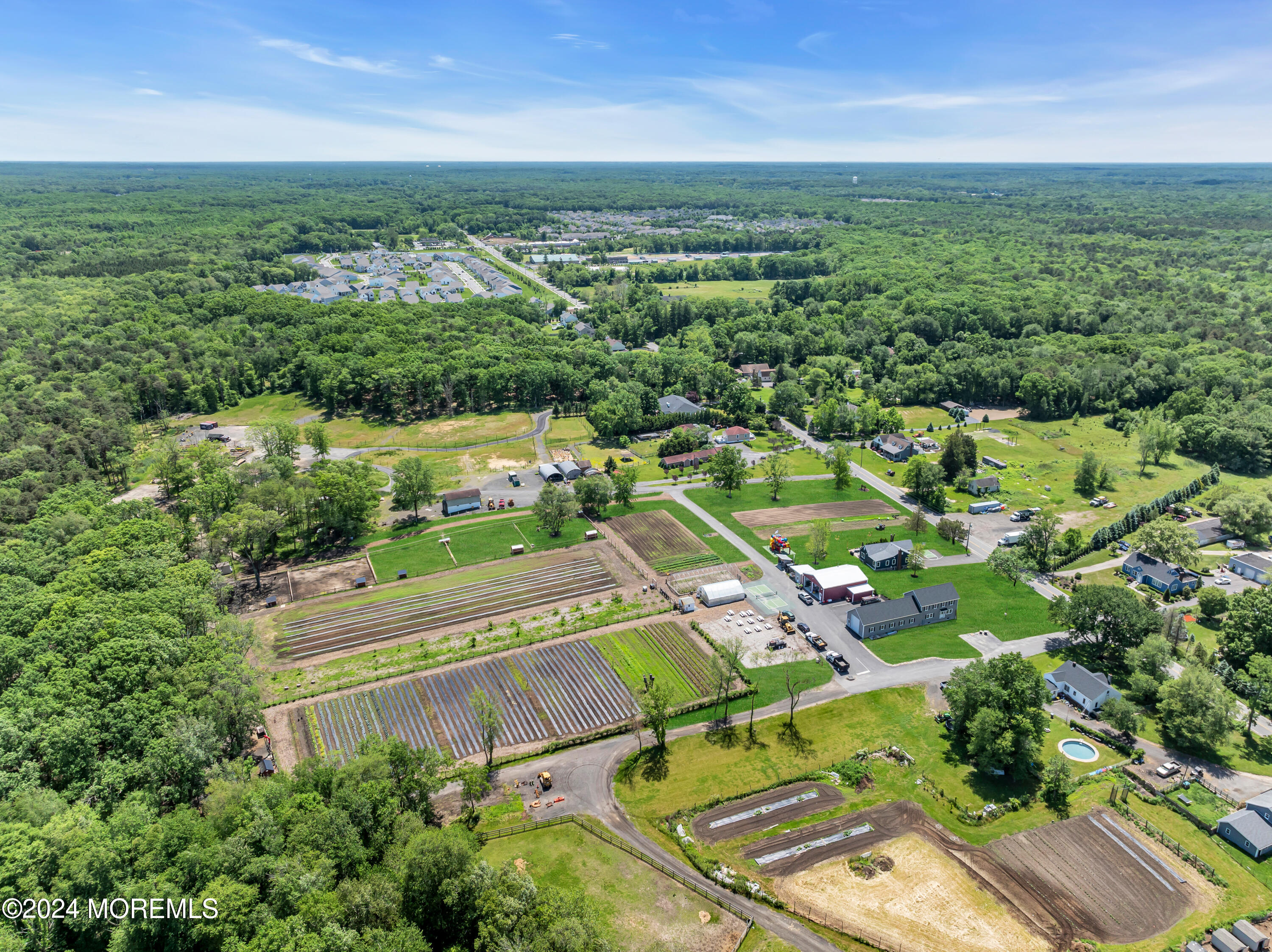 553 Colts Neck Road Farmingdale, NJ 07727 - Photo 12 of 52 an aerial view of residential houses with outdoor space and trees