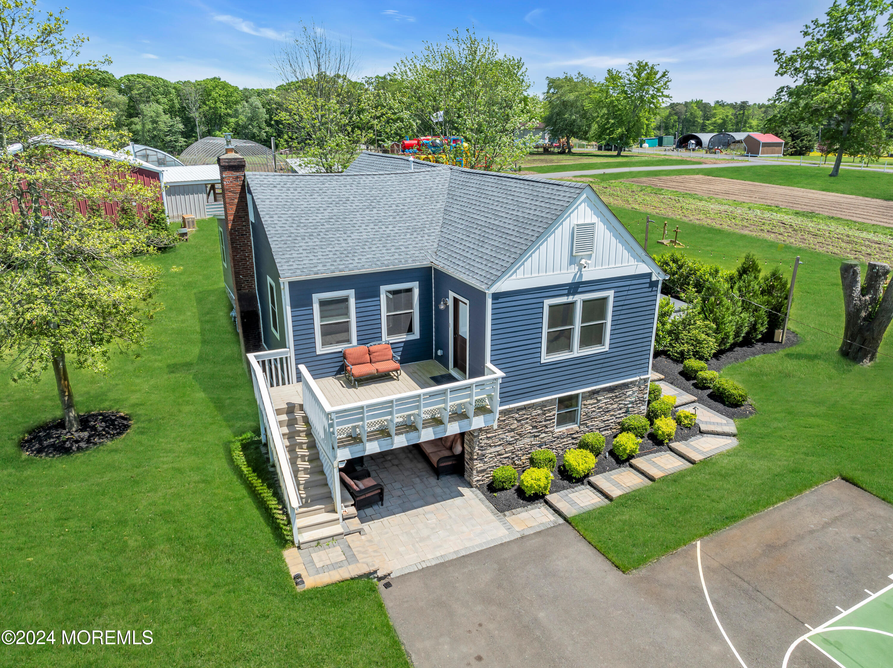 553 Colts Neck Road Farmingdale, NJ 07727 - Photo 22 of 52 a aerial view of a house with swimming pool and garden