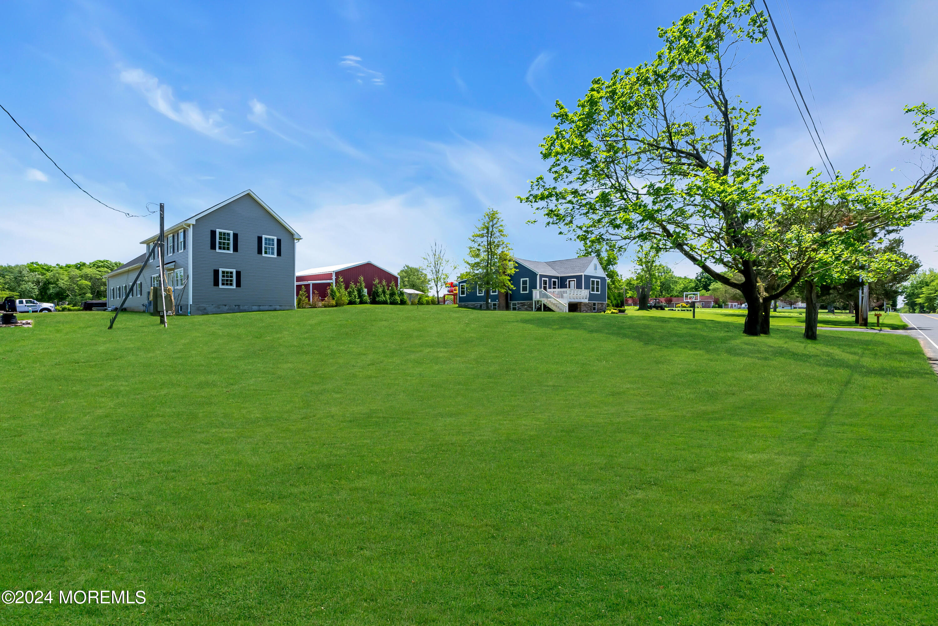 553 Colts Neck Road Farmingdale, NJ 07727 - Photo 26 of 52 a view of a big house with a big yard and large trees