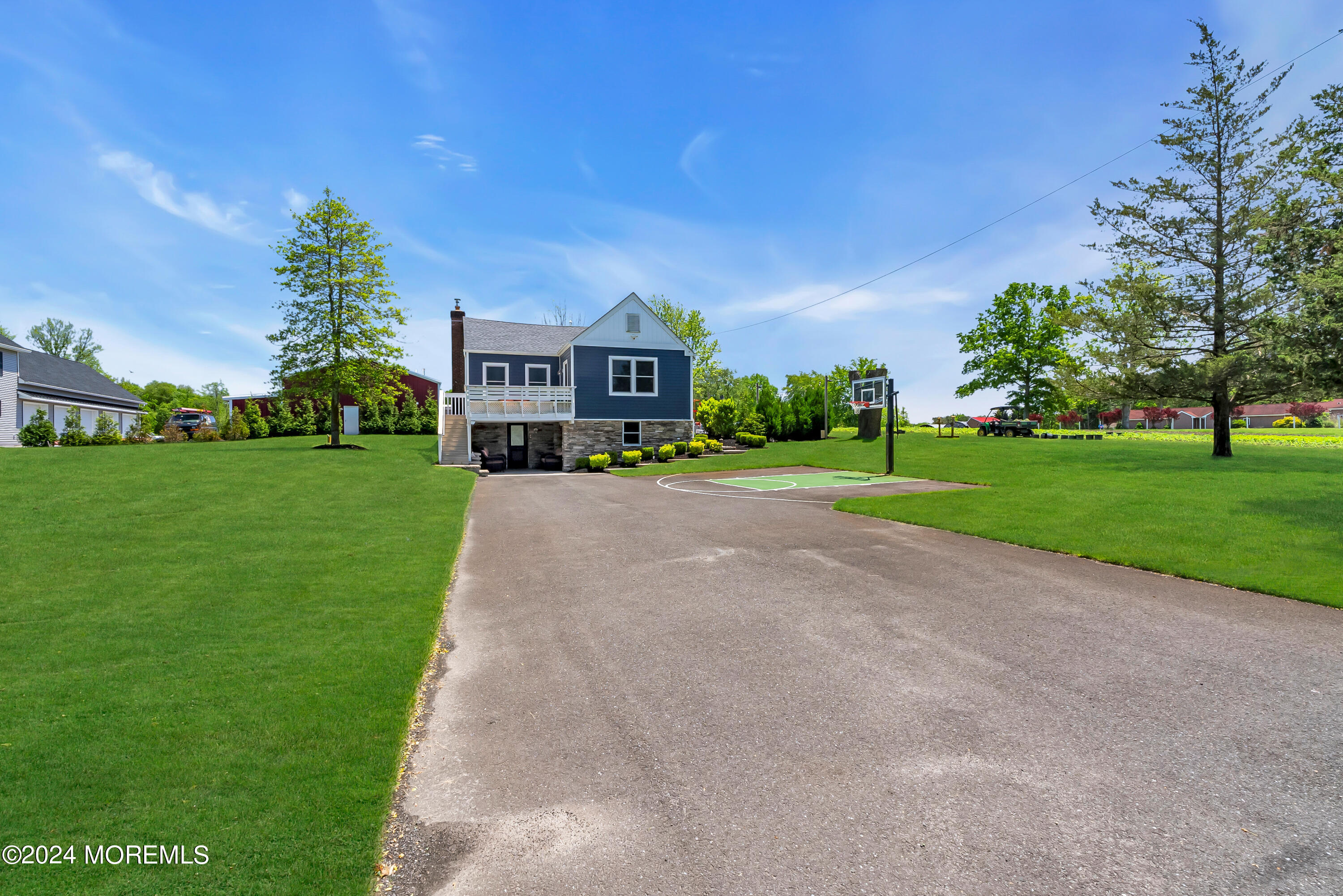 553 Colts Neck Road Farmingdale, NJ 07727 - Photo 27 of 52 a front view of a house with a yard and garage