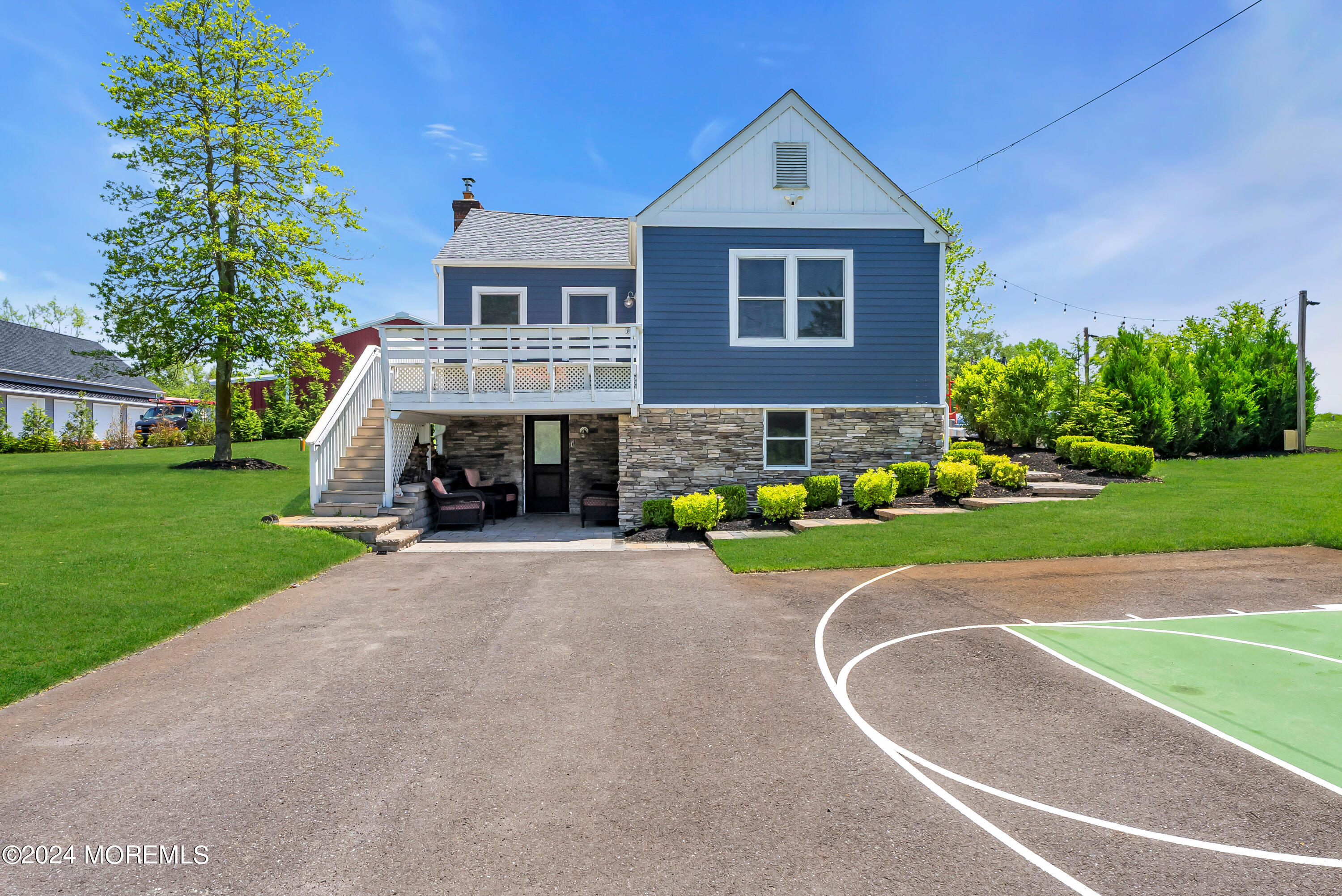 553 Colts Neck Road Farmingdale, NJ 07727 - Photo 31 of 52 a front view of a house with a yard and trees