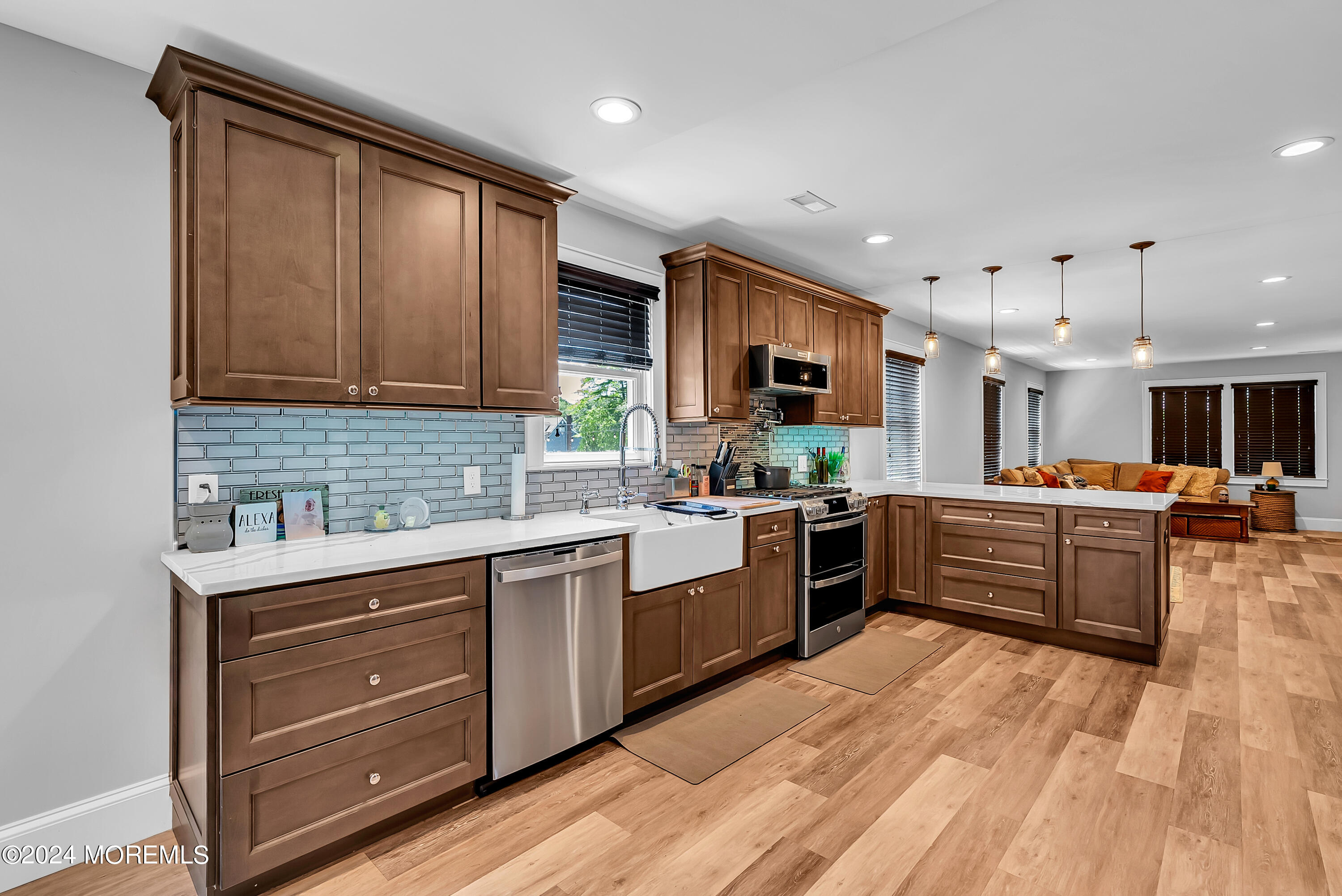 553 Colts Neck Road Farmingdale, NJ 07727 - Photo 37 of 52 a large kitchen with stainless steel appliances granite countertop a stove top oven a sink dishwasher and a microwave oven with large wooden cabinets
