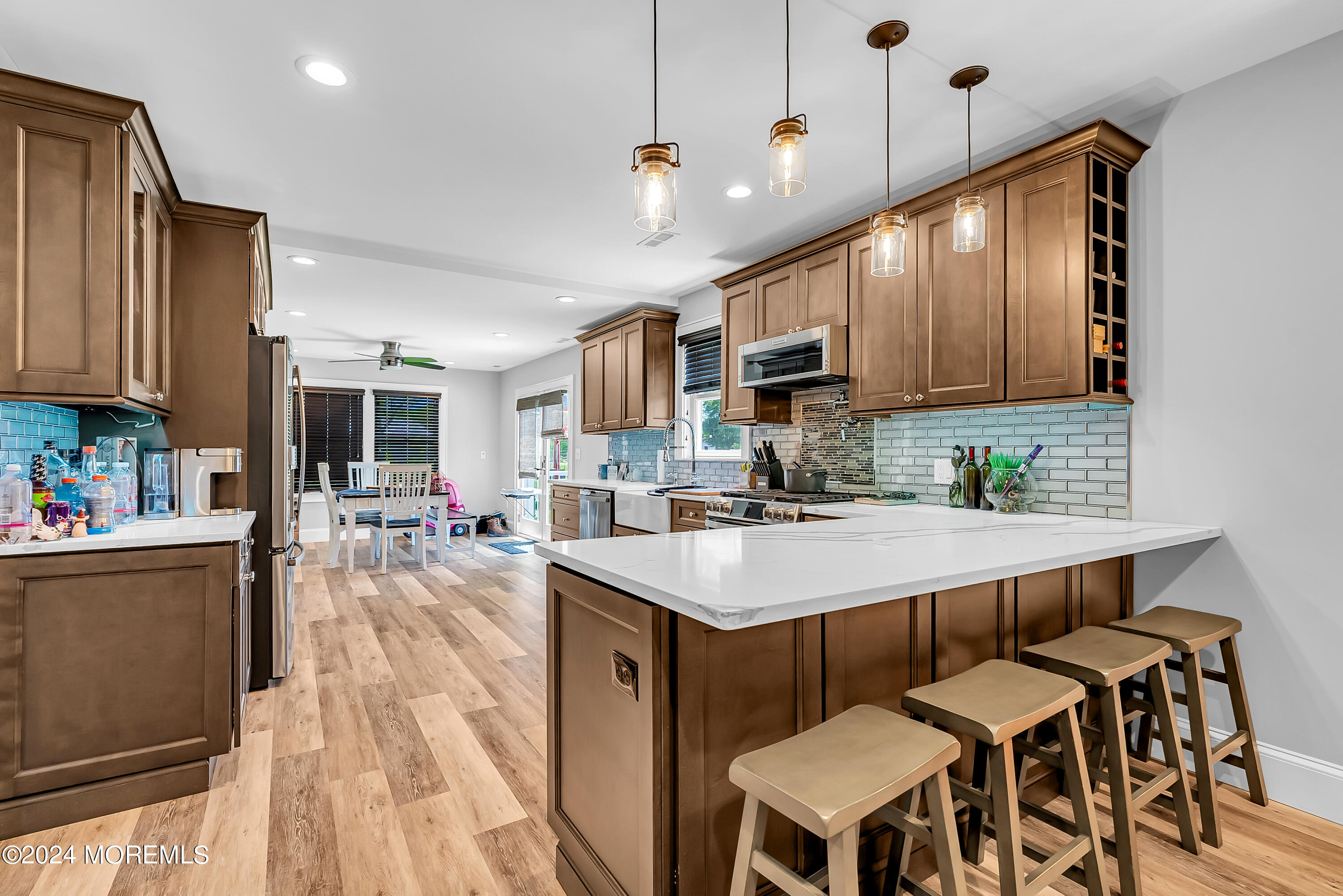 553 Colts Neck Road Farmingdale, NJ 07727 - Photo 40 of 52 a kitchen with kitchen island granite countertop a sink appliances and cabinets