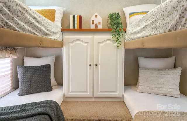 a bedroom with a bed and cabinets