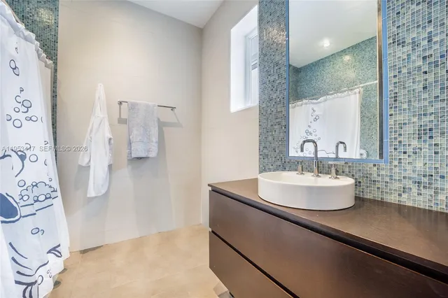a bathroom with a sink double vanity and a mirror