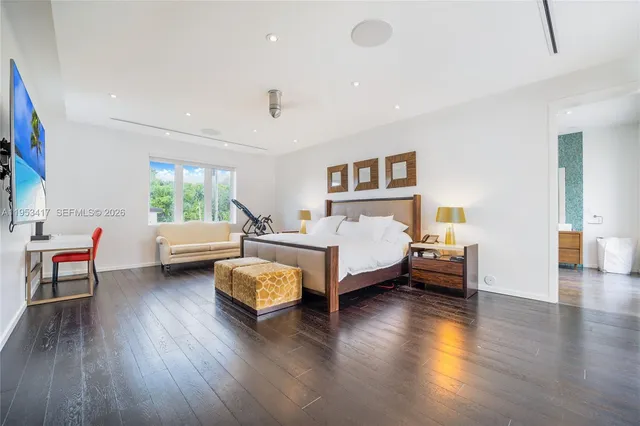 a bedroom with a bed and a wooden floor