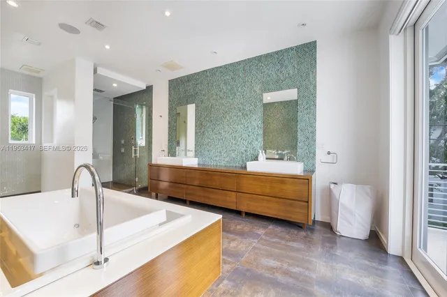 a bathroom with a sink a mirror and a bathtub