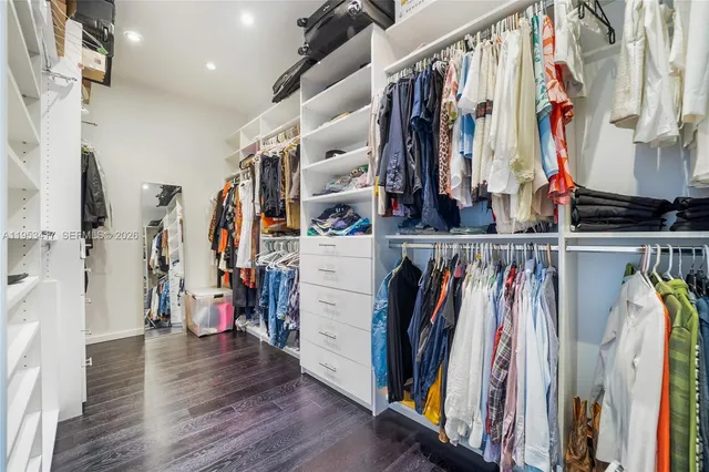 a view of walk in closet with clothes