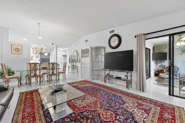 a balcony with furniture and a floor to ceiling window