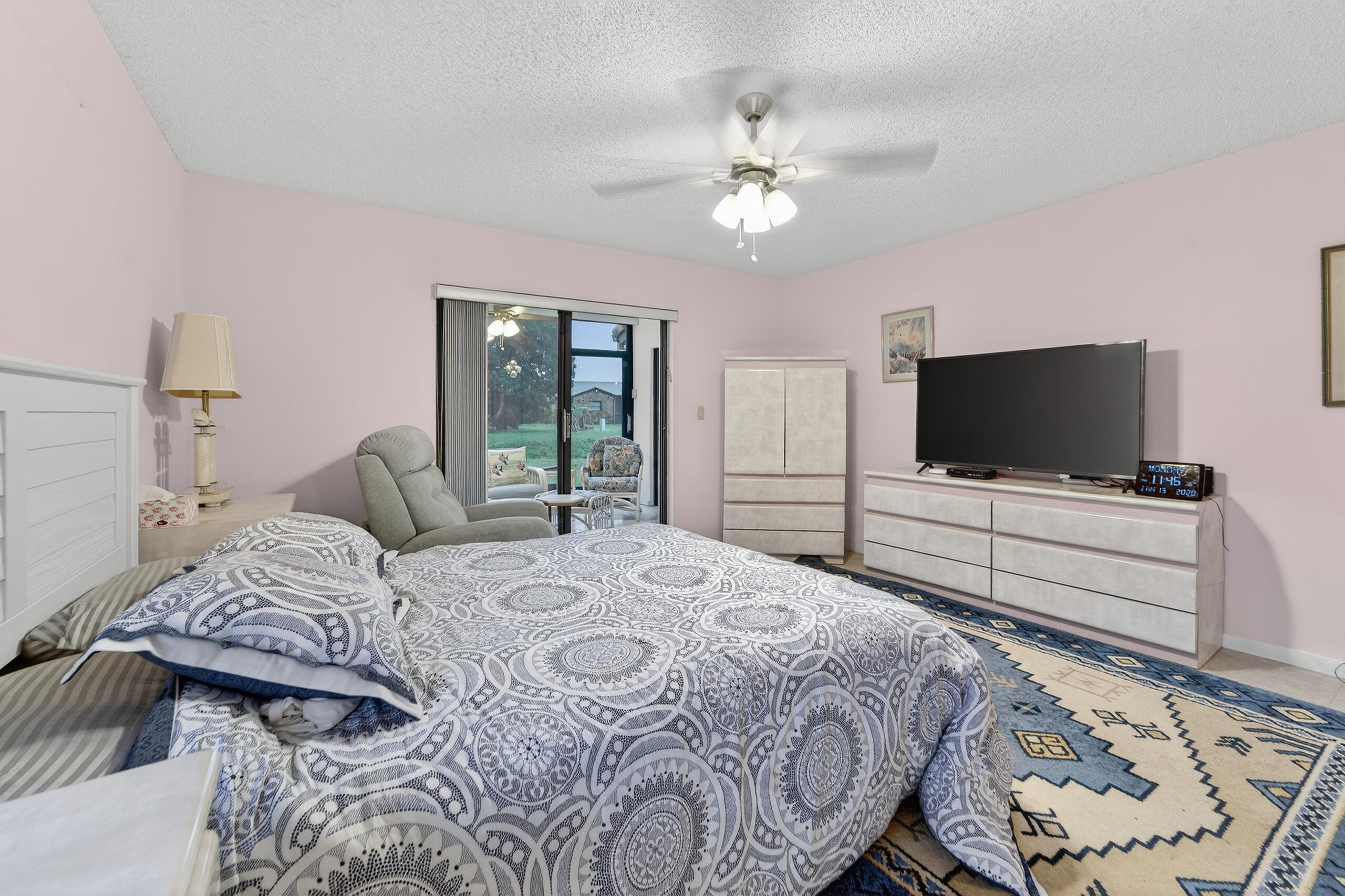 6220 Kings Gate Circle Delray Beach, FL 33484 - Photo 18 of 59 a bedroom with a bed and a flat screen tv