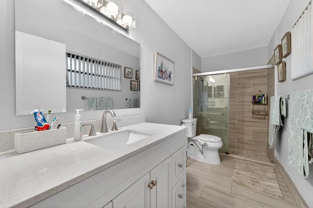 a bathroom with a sink a toilet and mirror