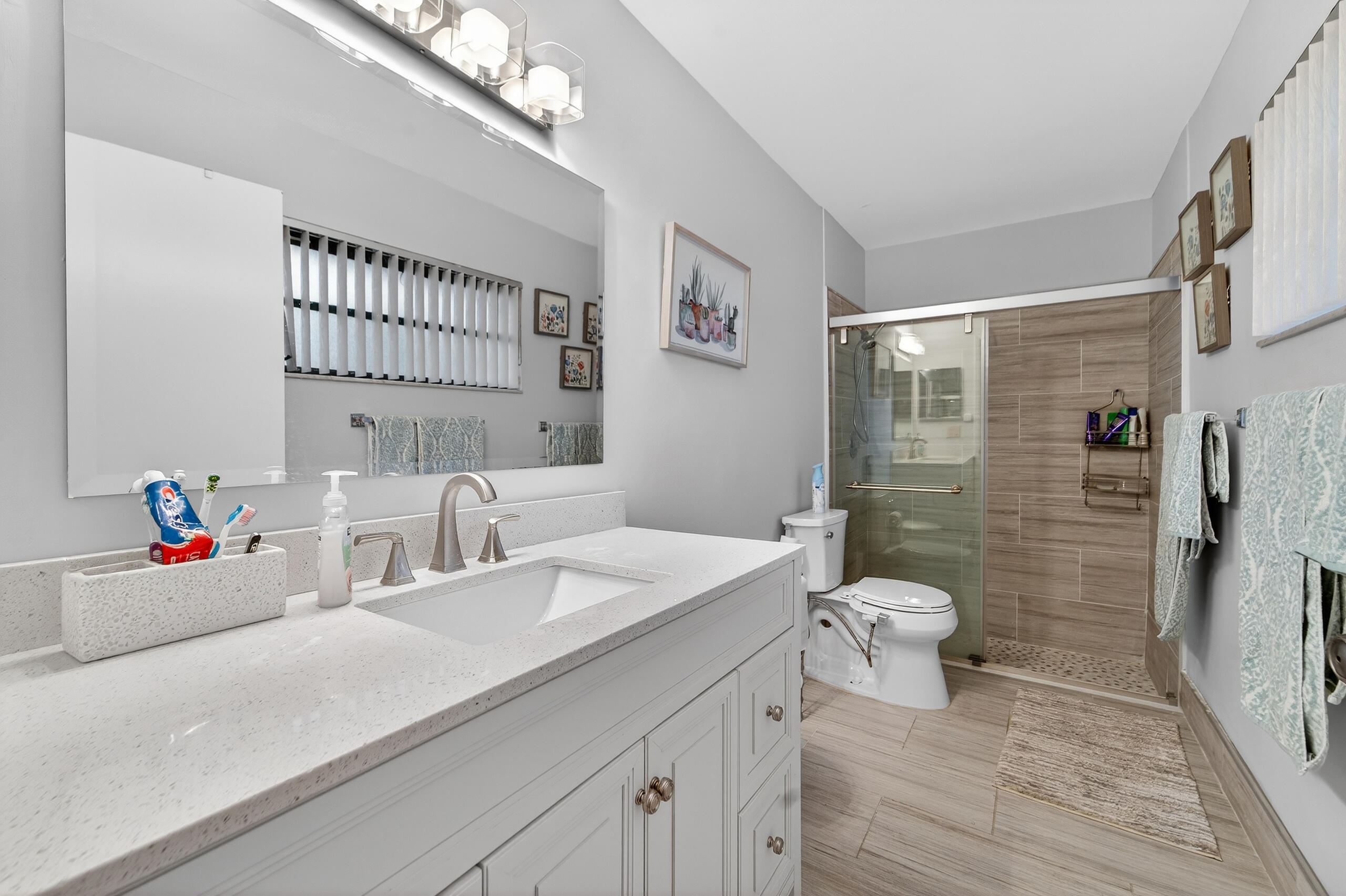 6220 Kings Gate Circle Delray Beach, FL 33484 - Photo 20 of 59 a bathroom with a sink toilet and shower