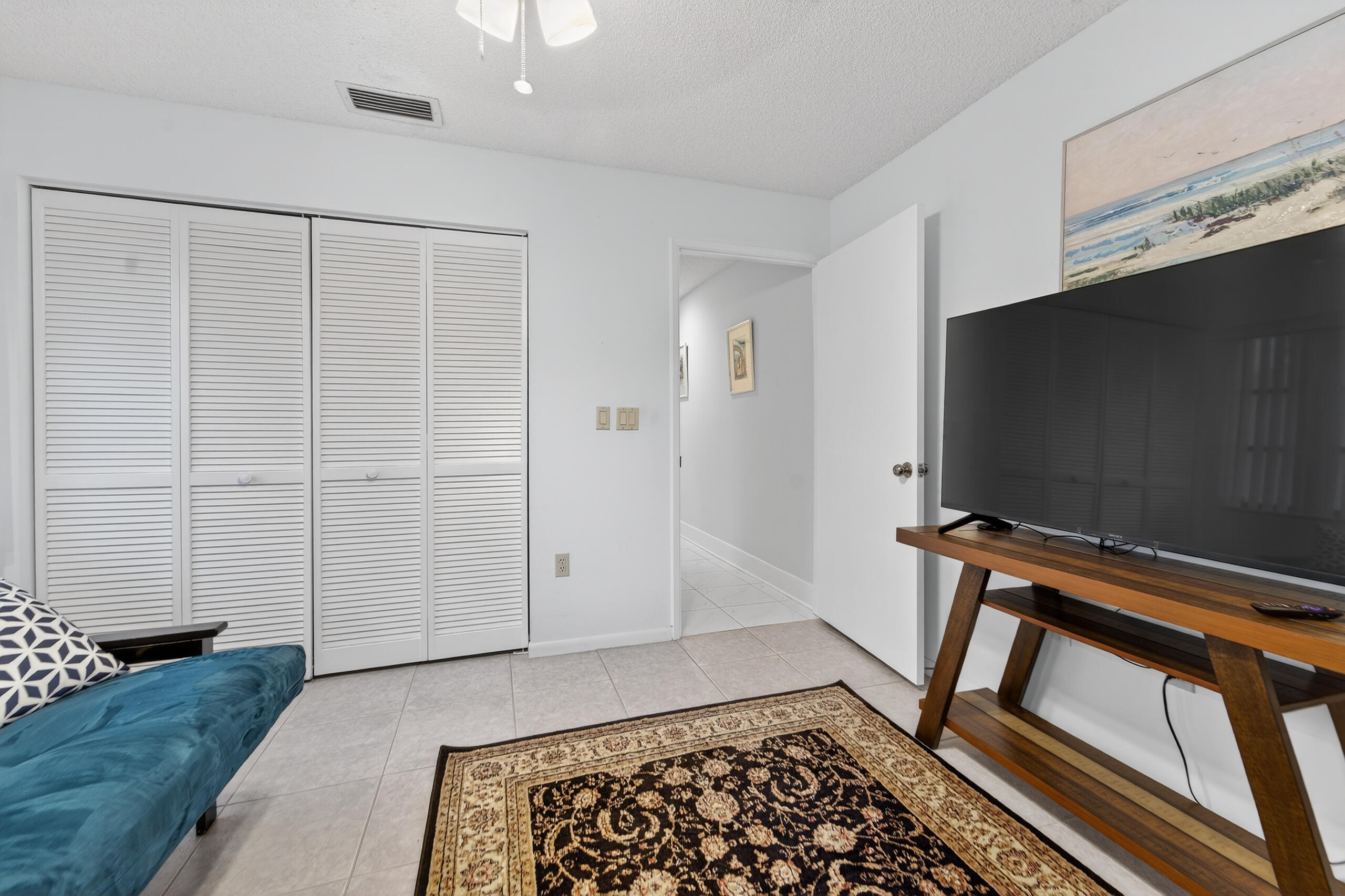 6220 Kings Gate Circle Delray Beach, FL 33484 - Photo 27 of 59 a living room with a flat screen tv and rug