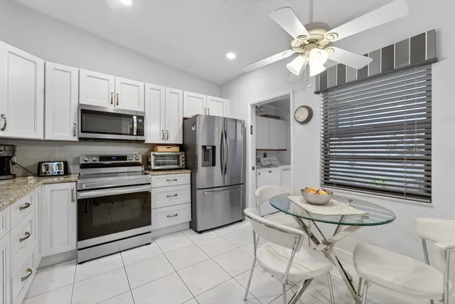 a kitchen with cabinets stainless steel appliances and a counter space