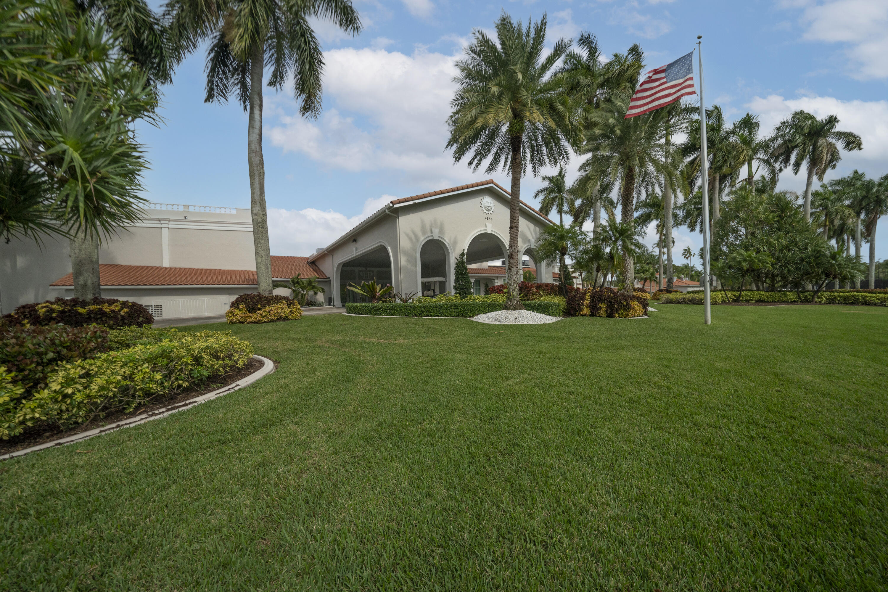 6220 Kings Gate Circle Delray Beach, FL 33484 - Photo 57 of 59 a view of white house with a big yard and palm trees