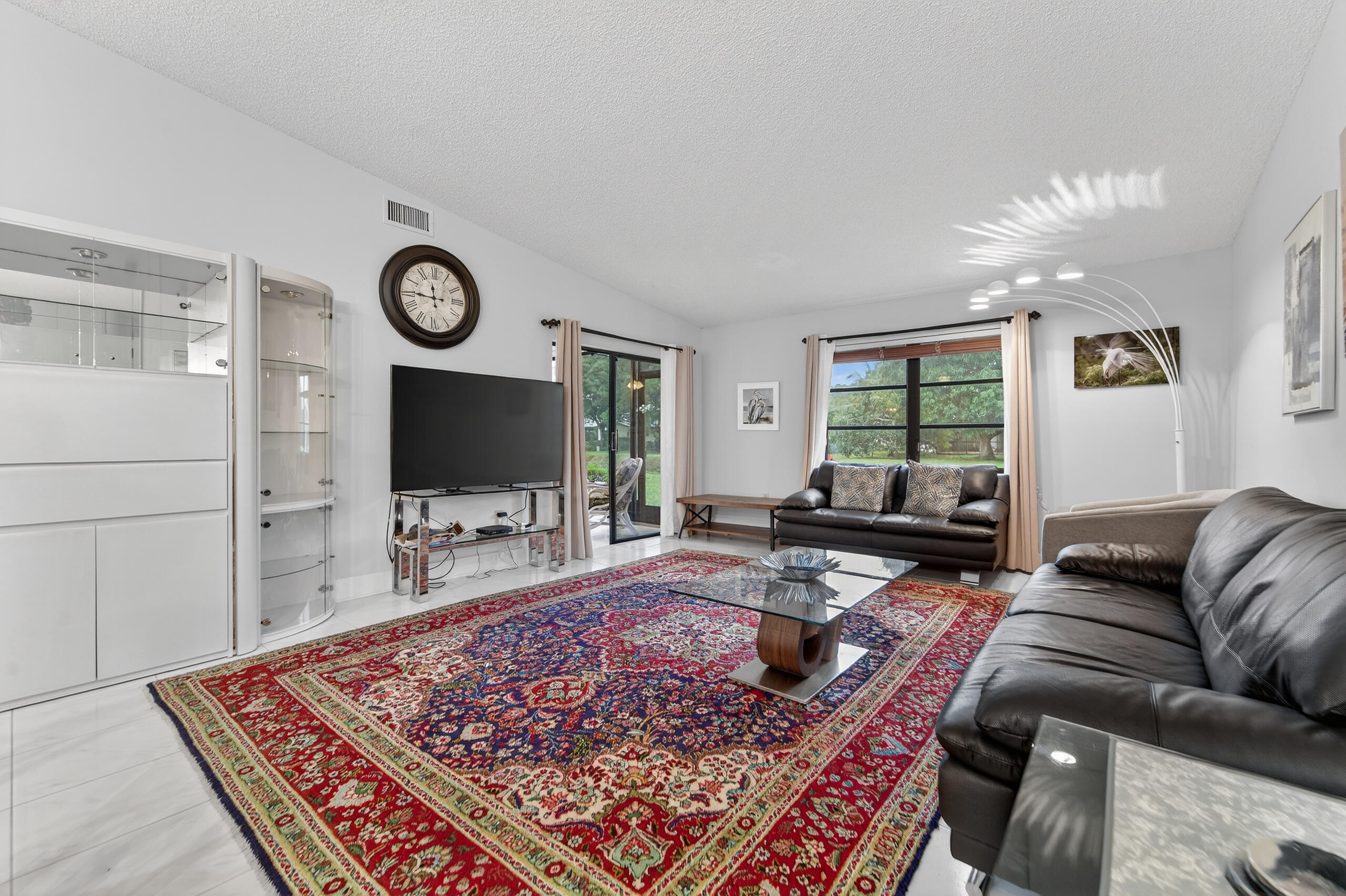 6220 Kings Gate Circle Delray Beach, FL 33484 - Photo 10 of 59 a living room with furniture and a flat screen tv