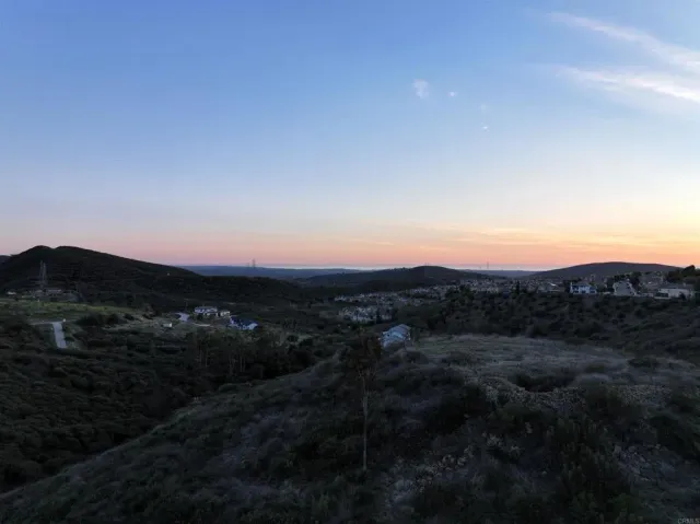 a view of a large mountain with mountains in the background