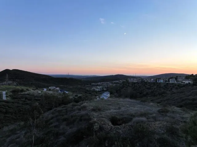 a view of a town with mountains in the background
