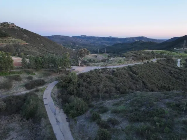 a view of a lush green outdoor space with a lake view