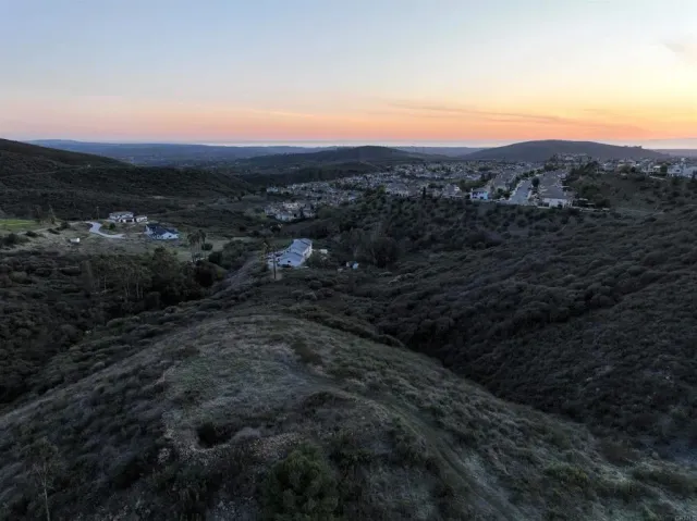 a view of a large building with mountains in the background