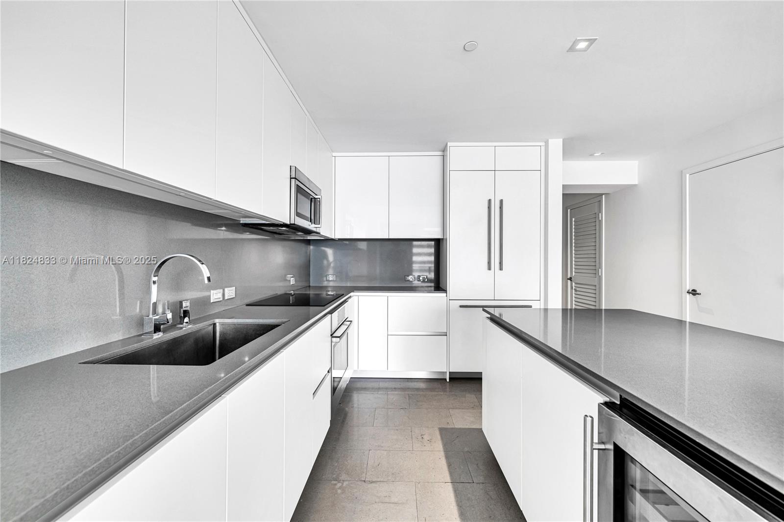 88 Southwest 7th Street, Unit 1006 Miami, FL 33130 - Photo 16 of 24 a kitchen with stainless steel appliances a sink a stove and cabinets