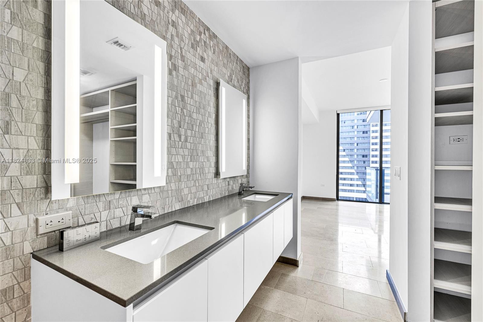 88 Southwest 7th Street, Unit 1006 Miami, FL 33130 - Photo 21 of 24 a bathroom with a granite countertop sink and a bathtub