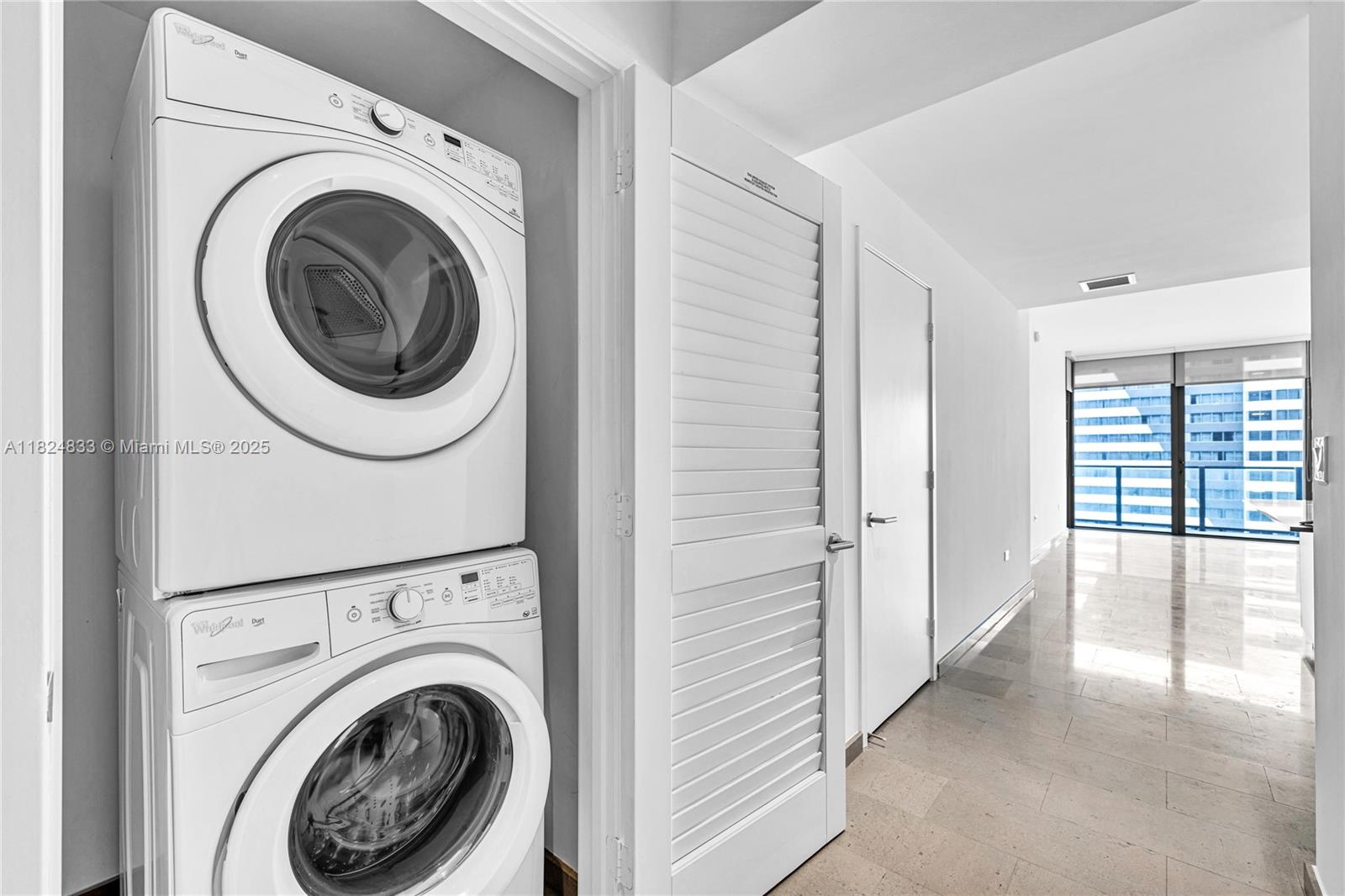 88 Southwest 7th Street, Unit 1006 Miami, FL 33130 - Photo 24 of 24 a view of a hallway with washer and dryer