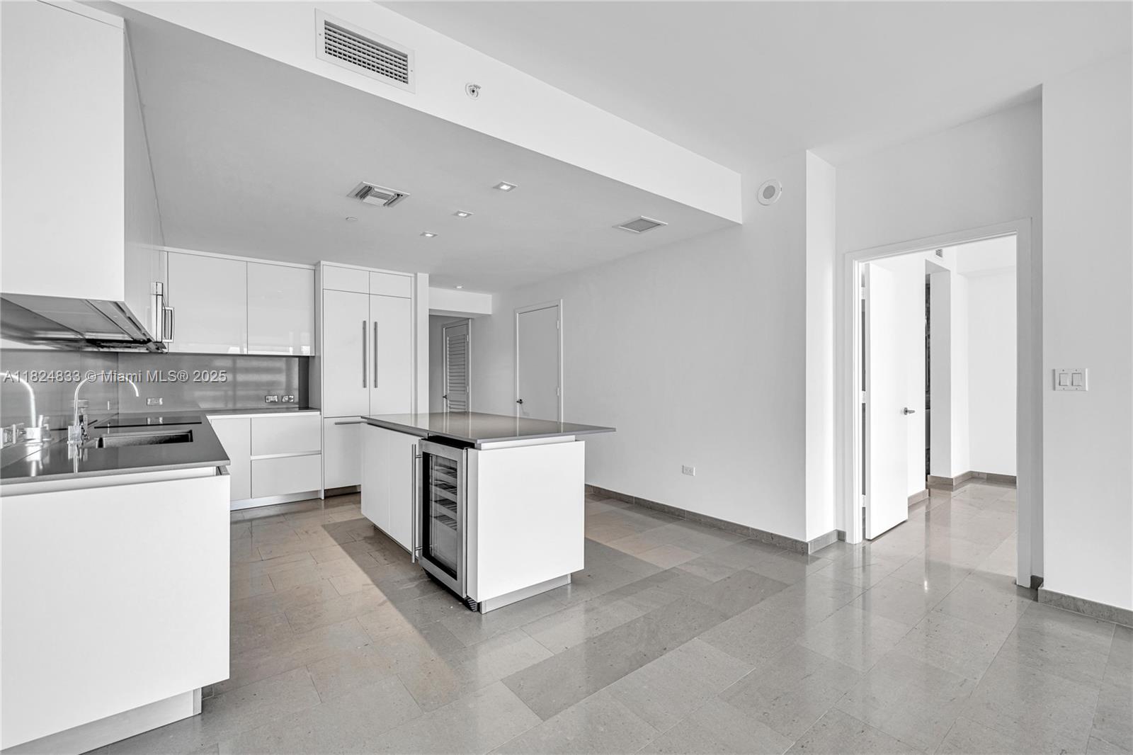 88 Southwest 7th Street, Unit 1006 Miami, FL 33130 - Photo 5 of 24 a kitchen with stainless steel appliances a stove a sink and white cabinets