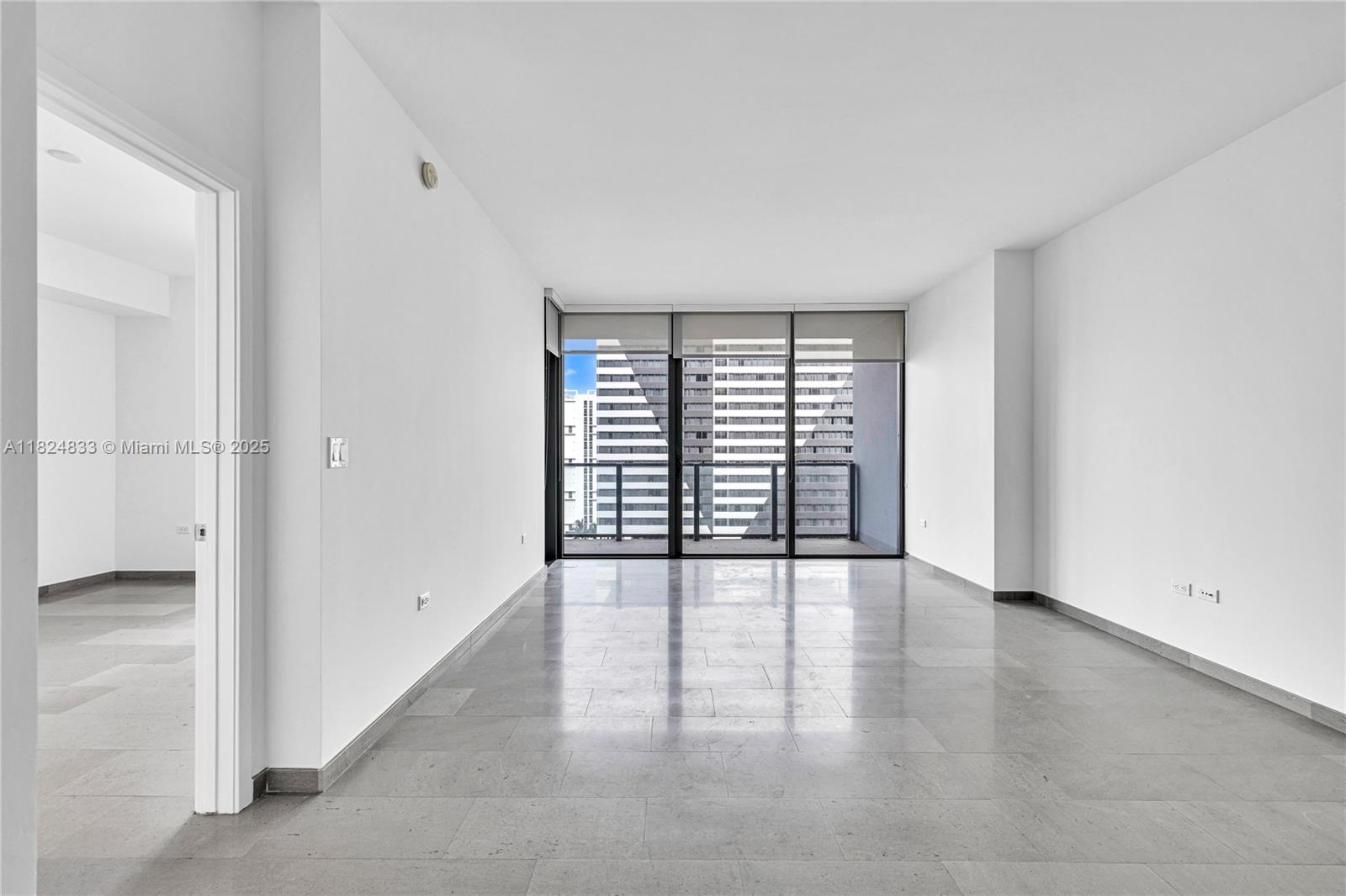 88 Southwest 7th Street, Unit 1006 Miami, FL 33130 - Photo 8 of 24 an empty room with wooden floor and windows