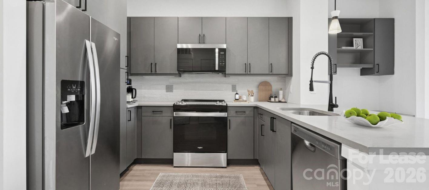 2222 North Tryon Street, Unit S3 Charlotte, NC 28206 - Photo 6 of 12 a kitchen with stainless steel appliances granite countertop a refrigerator and a sink