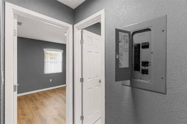 a view of a hallway with wooden floor and closet