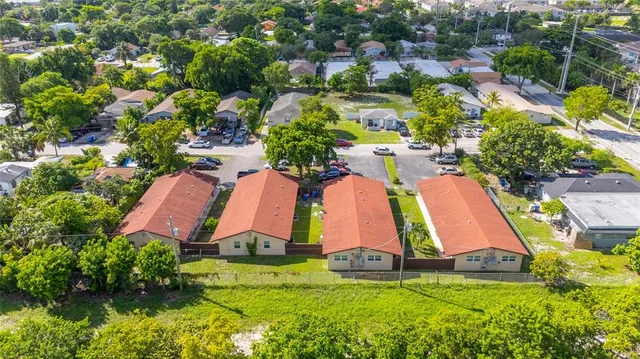 an aerial view of residential houses with outdoor space and swimming pool