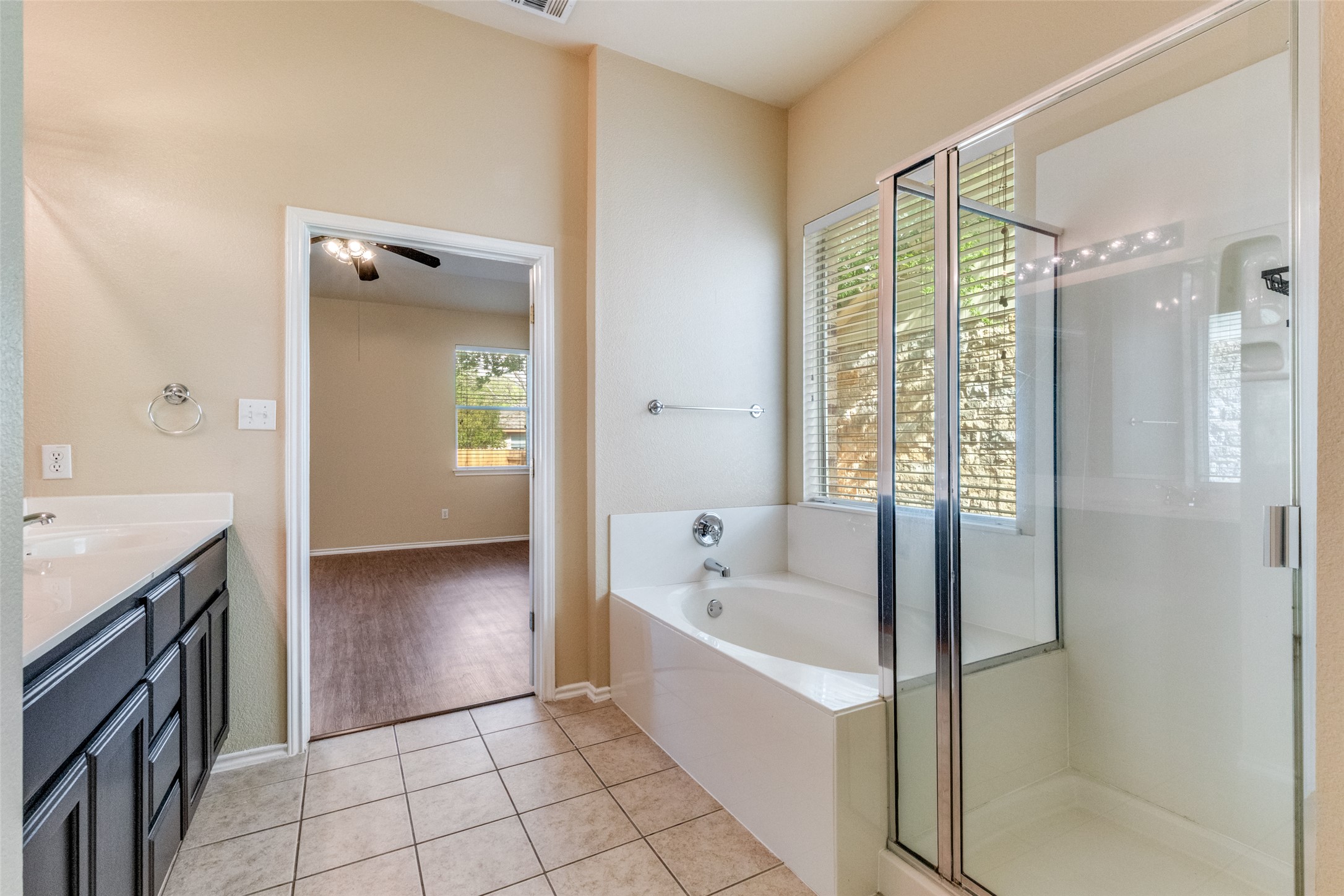 3816 Bandice Lane Pflugerville, TX 78660 - Photo 18 of 33 Full bath with vanity, a bath, a shower stall, and light tile patterned flooring