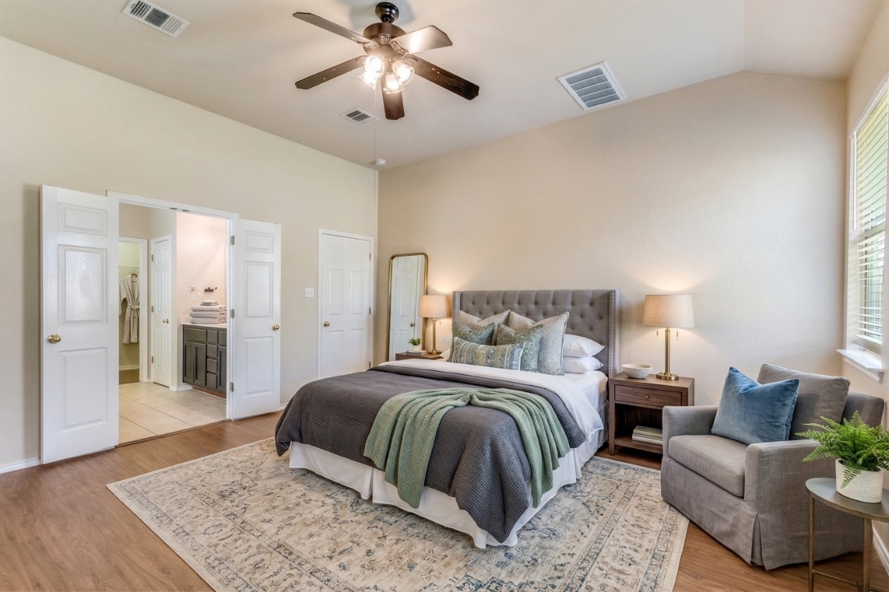 3816 Bandice Lane Pflugerville, TX 78660 - Photo 20 of 33 Bedroom featuring connected bathroom, light wood finished floors, lofted ceiling, and a ceiling fan