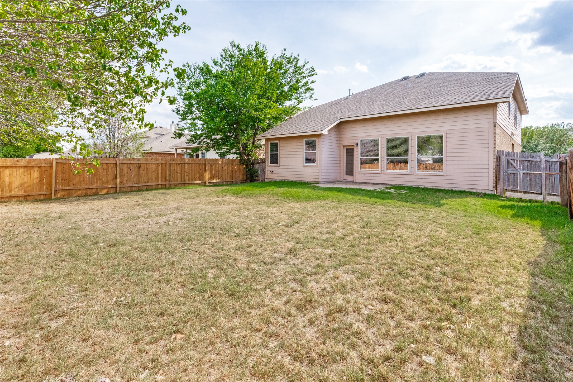 3816 Bandice Lane Pflugerville, TX 78660 - Photo 28 of 33 Back of property with a fenced backyard, a patio, a gate, and a shingled roof
