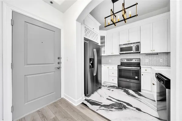 a kitchen with stainless steel appliances a refrigerator stove and cabinets