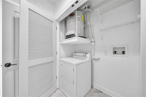 a view of a hallway with wooden floor and cabinets